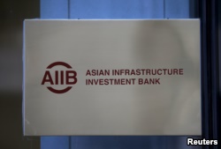 FILE - The signboard of Asian Infrastructure Investment Bank (AIIB) is seen at its headquarters in Beijing January 17, 2016.